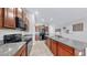 Well-equipped kitchen featuring granite countertops, stylish cabinets and modern black appliances at 10205 Cool Waterlily Ave, Riverview, FL 33578