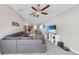 Open-concept living room with tile floors, ceiling fan, and seamless flow to the dining and kitchen areas at 10205 Cool Waterlily Ave, Riverview, FL 33578