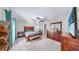 Main bedroom featuring modern wood furniture, fan, and mounted TV at 10205 Cool Waterlily Ave, Riverview, FL 33578