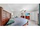 Main bedroom featuring wood furniture, fan, and mounted TV at 10205 Cool Waterlily Ave, Riverview, FL 33578