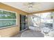 Covered back porch with a ceiling fan and patio furniture and view of the backyard at 10352 Lansfield St, Spring Hill, FL 34608