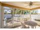 Screened in back porch with view of fenced yard, deck, and shed at 10352 Lansfield St, Spring Hill, FL 34608