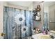 Bathroom with shower and flower-themed curtain at 10352 Lansfield St, Spring Hill, FL 34608