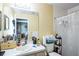 Bright bathroom with a mirror, vanity, and shower with curtain at 10352 Lansfield St, Spring Hill, FL 34608