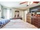 Comfortable bedroom featuring a ceiling fan, dresser, and a wall-mounted television at 10352 Lansfield St, Spring Hill, FL 34608