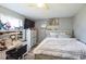 Well-lit bedroom showcasing a desk area, dresser, and a cozy bed at 10352 Lansfield St, Spring Hill, FL 34608