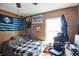 Comfortable bedroom featuring hardwood floors, natural lighting, and a fan at 10352 Lansfield St, Spring Hill, FL 34608