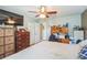 Spacious bedroom featuring a ceiling fan, closet space, and an attached desk area at 10352 Lansfield St, Spring Hill, FL 34608