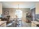 Cozy dining area featuring tile floors, a chandelier, and natural light at 10352 Lansfield St, Spring Hill, FL 34608