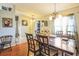 Elegant dining room featuring hardwood floors, a chandelier, and lots of natural light at 10352 Lansfield St, Spring Hill, FL 34608
