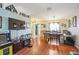 Spacious living area with hardwood floors, dining table, large screen television, and an open floorplan at 10352 Lansfield St, Spring Hill, FL 34608