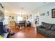 Open-concept living area with dining table, hardwood flooring, and a sectional sofa at 10352 Lansfield St, Spring Hill, FL 34608