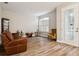 This cozy living room has new floors and a decorative glass front door at 10734 Banfield Dr, Riverview, FL 33579