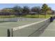 Community tennis court available for residents, showcasing a well-maintained court and seating for spectators at 10734 Banfield Dr, Riverview, FL 33579