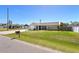 Landscaped front yard with an attached garage and a screened entryway at 1245 Porpoise Rd, Venice, FL 34293