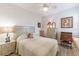 Charming bedroom with a neutral color scheme, complemented by hardwood floors and unique furniture at 129 Treviso Ct, North Venice, FL 34275