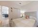 Light-filled bedroom with a neutral color palette, hardwood floors, and a glimpse of the living room at 129 Treviso Ct, North Venice, FL 34275