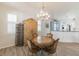 Charming dining area featuring a decorative chandelier and stylish table for elegant dining at 129 Treviso Ct, North Venice, FL 34275