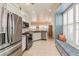 Bright, modern kitchen featuring stainless steel appliances, ample storage, and an eat-in dining area at 129 Treviso Ct, North Venice, FL 34275