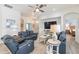Bright living room with comfortable seating, ceiling fan, and views of the foyer and bedroom at 129 Treviso Ct, North Venice, FL 34275