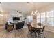 Expansive living and dining area with ample natural light, hardwood floors and stylish furniture at 129 Treviso Ct, North Venice, FL 34275