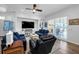 Open living room with neutral colors, hardwood flooring, large window, and modern furniture at 129 Treviso Ct, North Venice, FL 34275