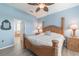 Comfortable main bedroom with light-blue walls, hardwood floors, and an elegant wooden bed frame at 129 Treviso Ct, North Venice, FL 34275