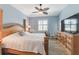 Cozy main bedroom features light-blue walls, hardwood floors, a dresser, and a white accent chair at 129 Treviso Ct, North Venice, FL 34275