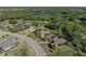 Aerial view of a home near a lake, golf course and other homes at 13551 Carnoustie Cir, Dade City, FL 33525