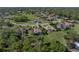 Aerial view of a home near a lake, golf course and other homes at 13551 Carnoustie Cir, Dade City, FL 33525