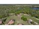 Aerial view showcasing a golf course, a lake, and luxury homes in a scenic community at 13551 Carnoustie Cir, Dade City, FL 33525