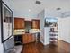 Home bar features custom cabinetry, a wine fridge, and a TV for entertaining at 13551 Carnoustie Cir, Dade City, FL 33525