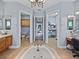 Bright bathroom features a jacuzzi tub, dual vanities, and separate toilet and walk in closet at 13551 Carnoustie Cir, Dade City, FL 33525
