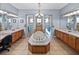 A centrally located soaking tub is surrounded by dual vanities and dual walk-in shower stalls at 13551 Carnoustie Cir, Dade City, FL 33525