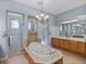 Bathroom featuring a soaking tub, walk-in shower stalls, and dual vanities at 13551 Carnoustie Cir, Dade City, FL 33525