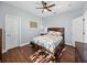 Bedroom featuring hardwood flooring, a ceiling fan, two doors, and furnishings at 13551 Carnoustie Cir, Dade City, FL 33525