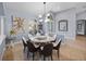 Elegant dining room with modern chandelier, stylish decor, and views to the entryway at 13551 Carnoustie Cir, Dade City, FL 33525