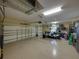 Large garage with storage cabinets, vehicle parking, and convenient access at 13551 Carnoustie Cir, Dade City, FL 33525