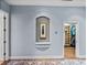 Hallway with a decorative niche and an entrance to a walk-in closet at 13551 Carnoustie Cir, Dade City, FL 33525