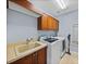 Convenient laundry room equipped with modern washer and dryer, sink and ample storage at 13551 Carnoustie Cir, Dade City, FL 33525
