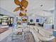 Bright and airy living room with a unique ceiling fan, open layout, and views to other living areas at 13551 Carnoustie Cir, Dade City, FL 33525