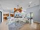 Open-concept living room with views to the dining room, kitchen, and other living areas at 13551 Carnoustie Cir, Dade City, FL 33525
