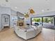 Inviting living room featuring a fireplace, tile floors, and seamless access to the outdoor pool area at 13551 Carnoustie Cir, Dade City, FL 33525