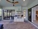 Inviting outdoor kitchen featuring a built-in grill, ceiling fan, and seamless access to indoor living spaces at 13551 Carnoustie Cir, Dade City, FL 33525