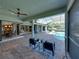 Inviting outdoor patio with pool views, seamless indoor/outdoor access, and comfortable seating at 13551 Carnoustie Cir, Dade City, FL 33525