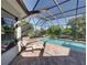 Beautiful screened pool with a spa, surrounded by lush greenery and offering a private retreat at 13551 Carnoustie Cir, Dade City, FL 33525