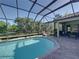 Spacious screened pool with patio and lush landscaping, perfect for outdoor entertaining and relaxation at 13551 Carnoustie Cir, Dade City, FL 33525