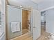 Walk-in shower with a glass door and tile surround, plus a view to hallway at 13551 Carnoustie Cir, Dade City, FL 33525