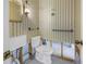 Bathroom with new toilet, mirror and patterned wallpaper at 13982 Whisperwood Dr, Clearwater, FL 33762