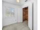 Bedroom featuring window, closet with cedar-planked walls, and ceiling fan at 13982 Whisperwood Dr, Clearwater, FL 33762